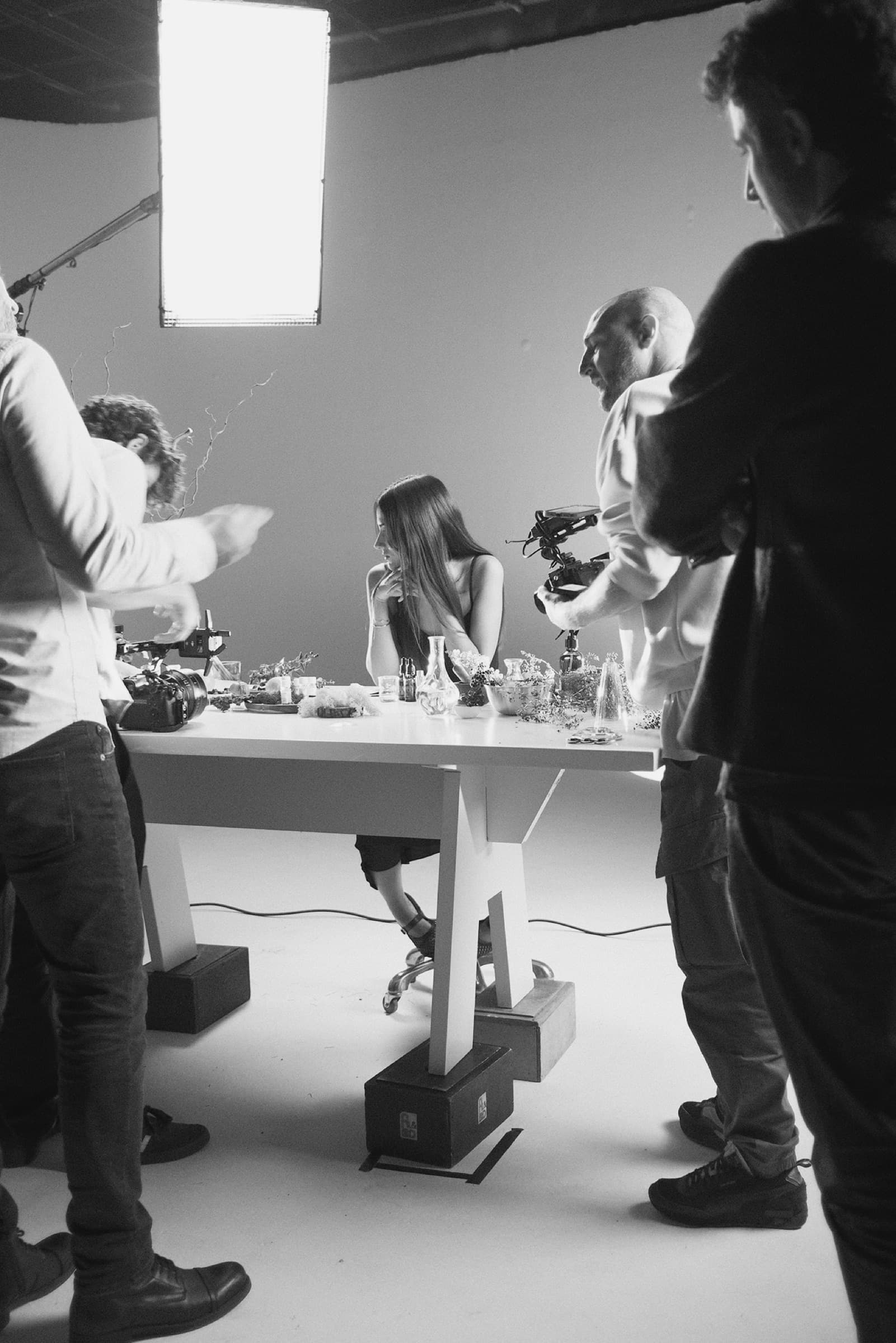 Ashley Santiago seated at the table while the crew prepares cameras around her