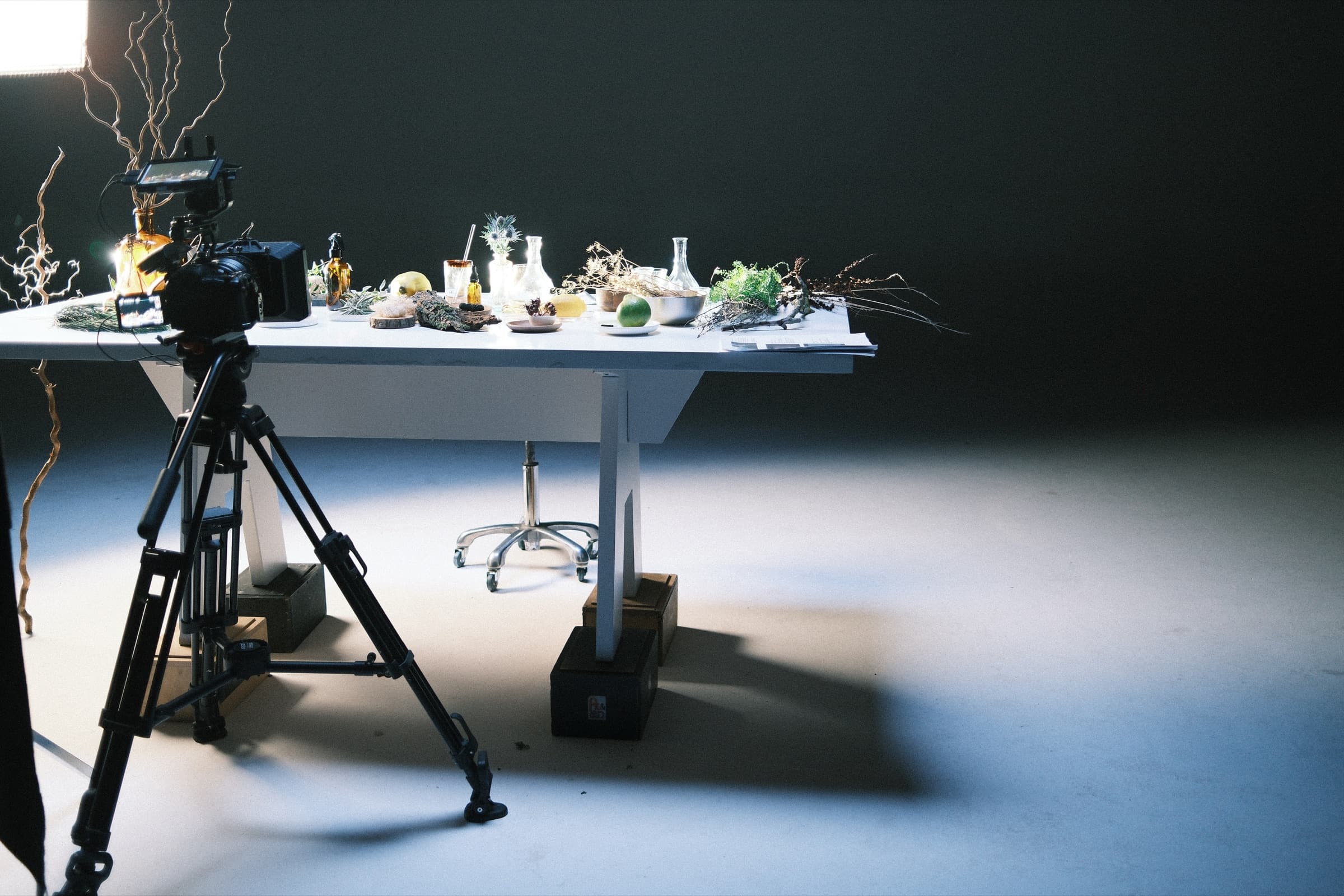 The raw-materials table and a camera on a tripod in an empty studio
